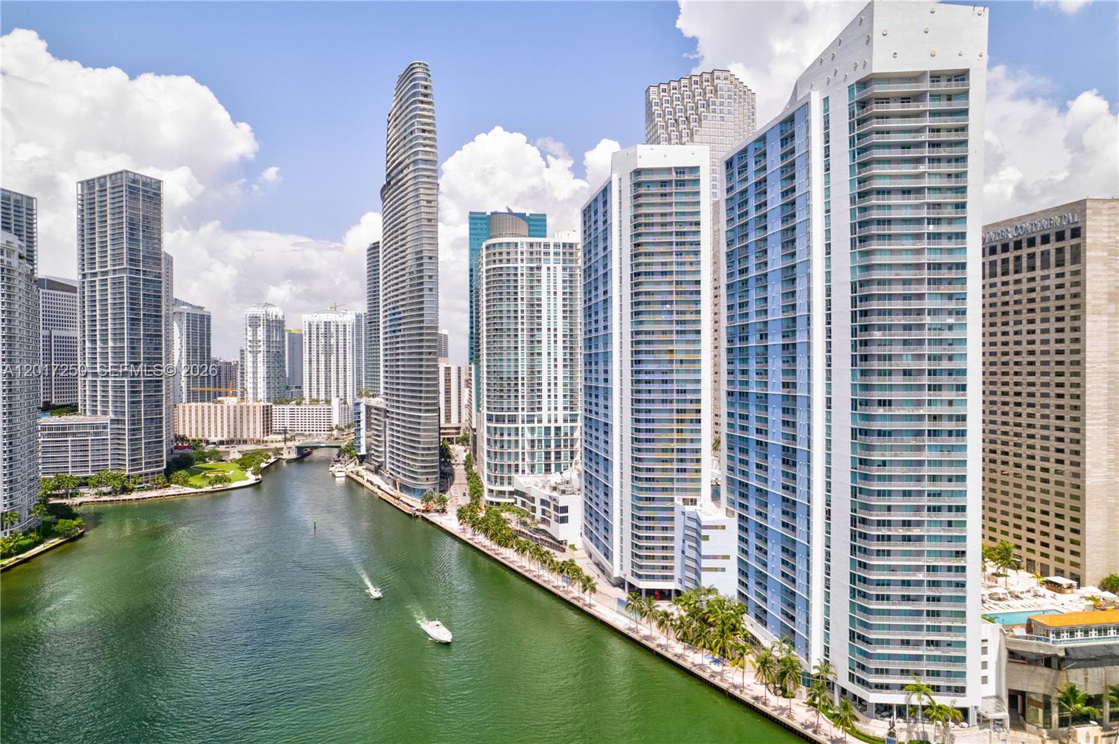 An aerial view of the Miami River lined with modern high-rise residential towers — 335 S Biscayne Blvd # 1209, Miami FL 33131, MIAMI, FL
