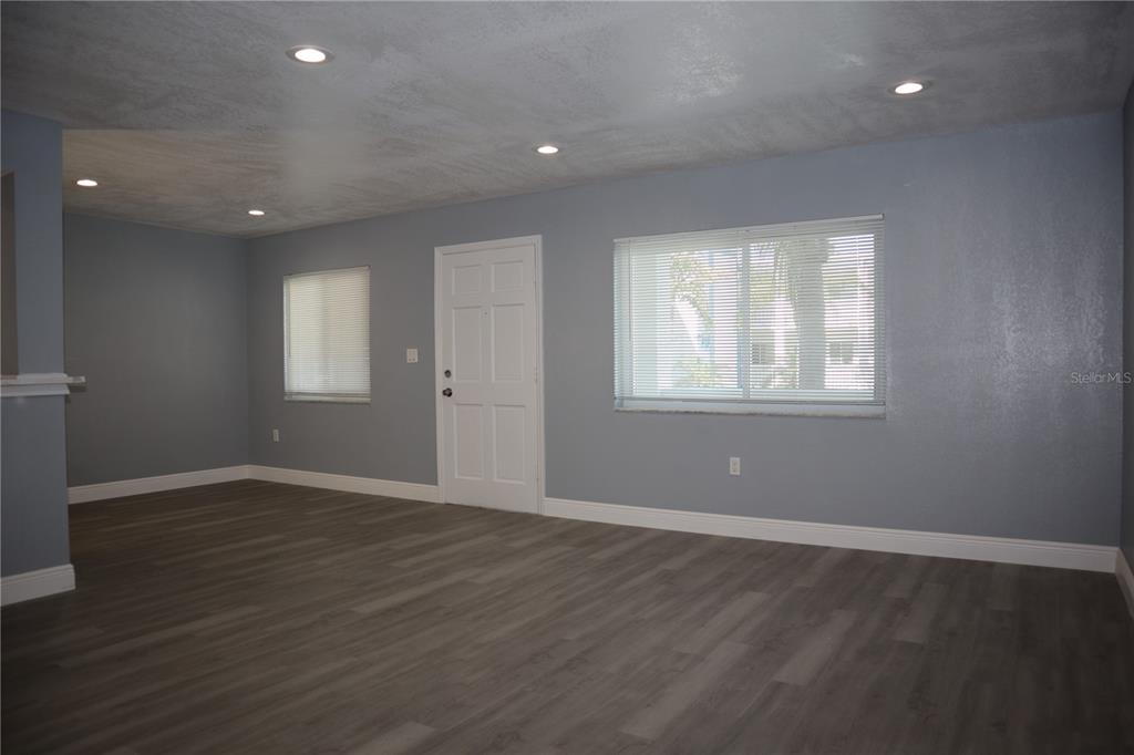 A room with gray walls, recessed lighting, a white door, and wood-look flooring — 350 79TH AVENUE N UNIT 236, ST PETERSBURG, FL