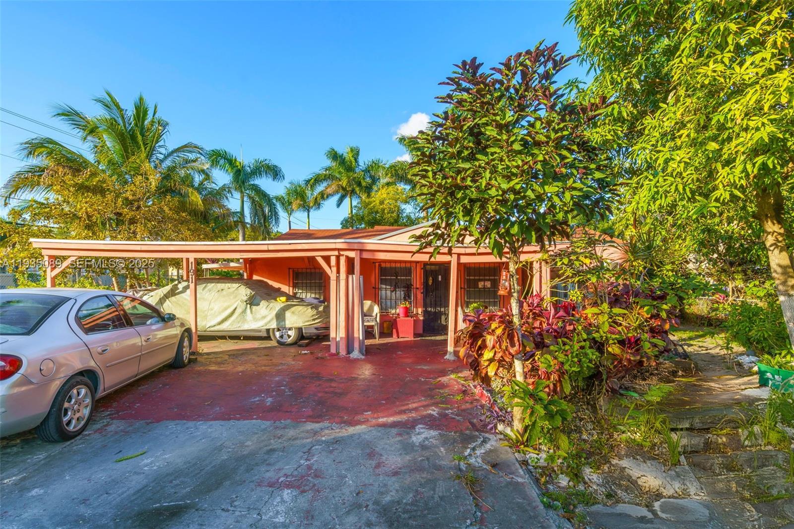 A single-story house with a carport, a covered porch, and a car parked in front — 191 NW 83rd St, Miami FL 33150, MIAMI, FL