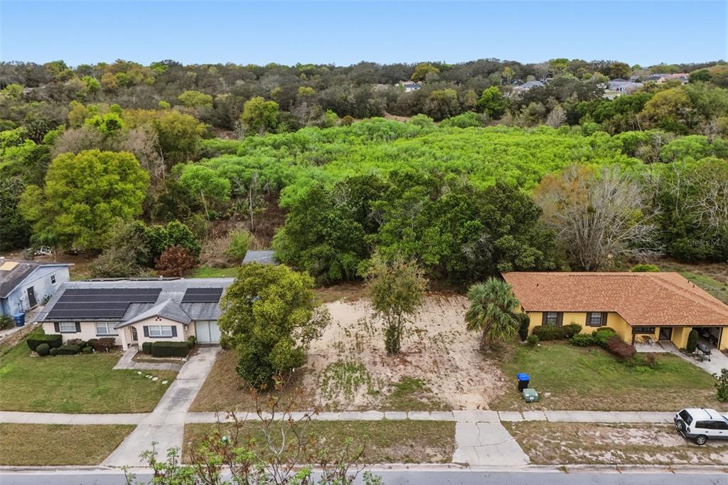 An aerial view shows a vacant residential lot situated between two single-story houses — 1670 S CENTRAL AVENUE, APOPKA, FL