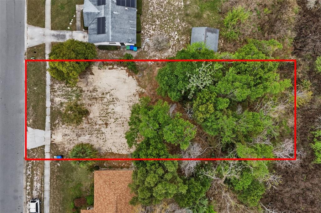 An aerial view shows a rectangular vacant lot with a cleared sandy area and trees — 1670 S CENTRAL AVENUE, APOPKA, FL