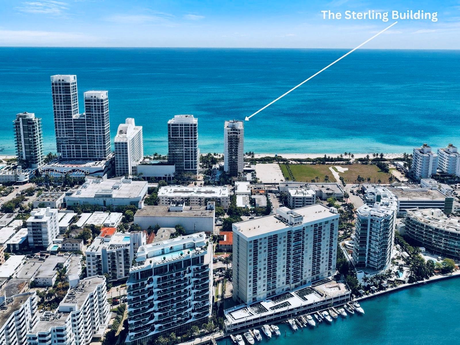 An aerial view of a coastal city skyline featuring high-rise buildings along the oceanfront — 6767 Collins Ave # 304, Miami Beach FL 33141, MIAMI BEACH, FL