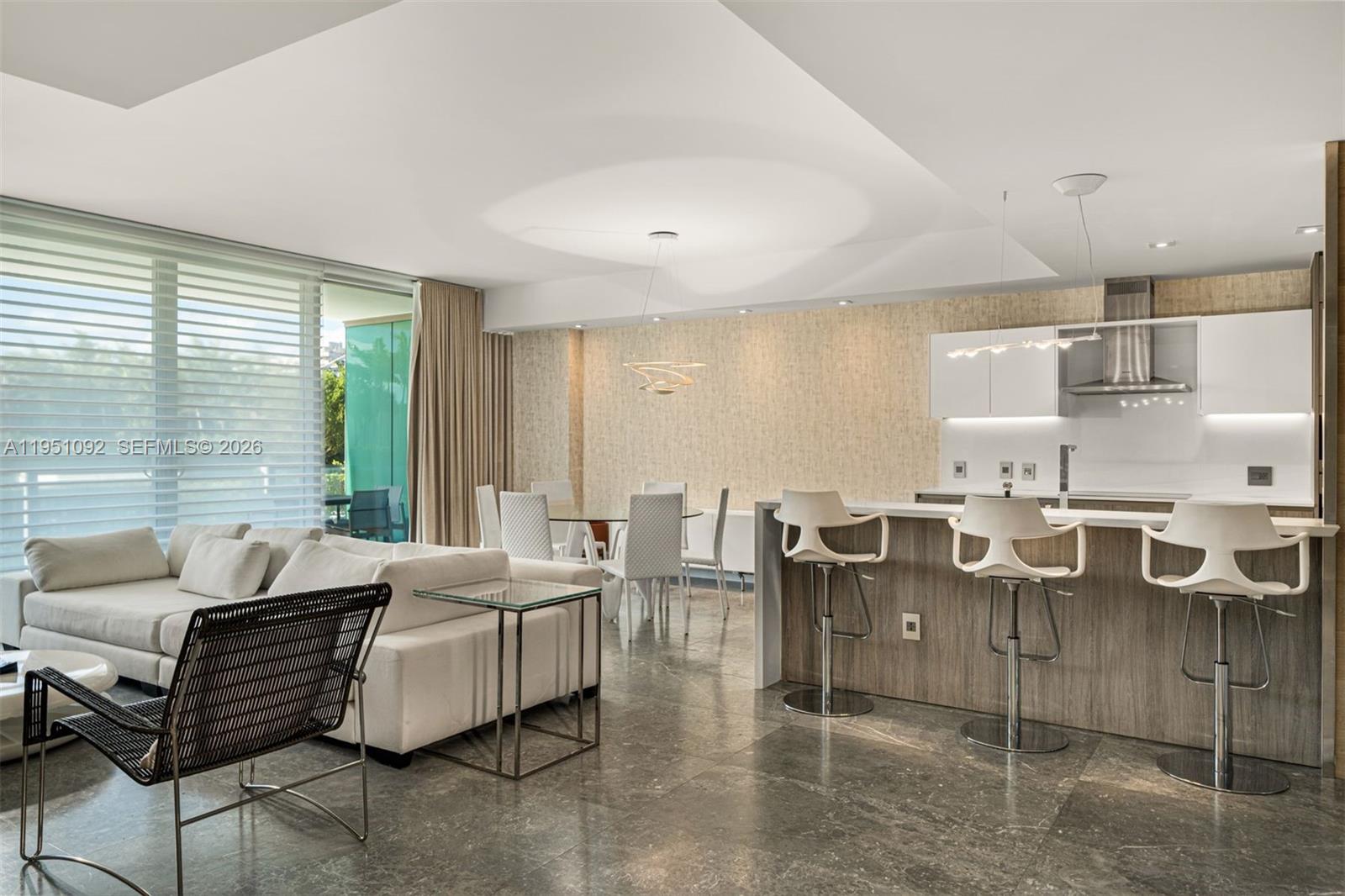 A modern open-concept living area features a kitchen with bar seating and a dining space — 350 Ocean Dr # 205N, Key Biscayne FL 33149, KEY BISCAYNE, FL