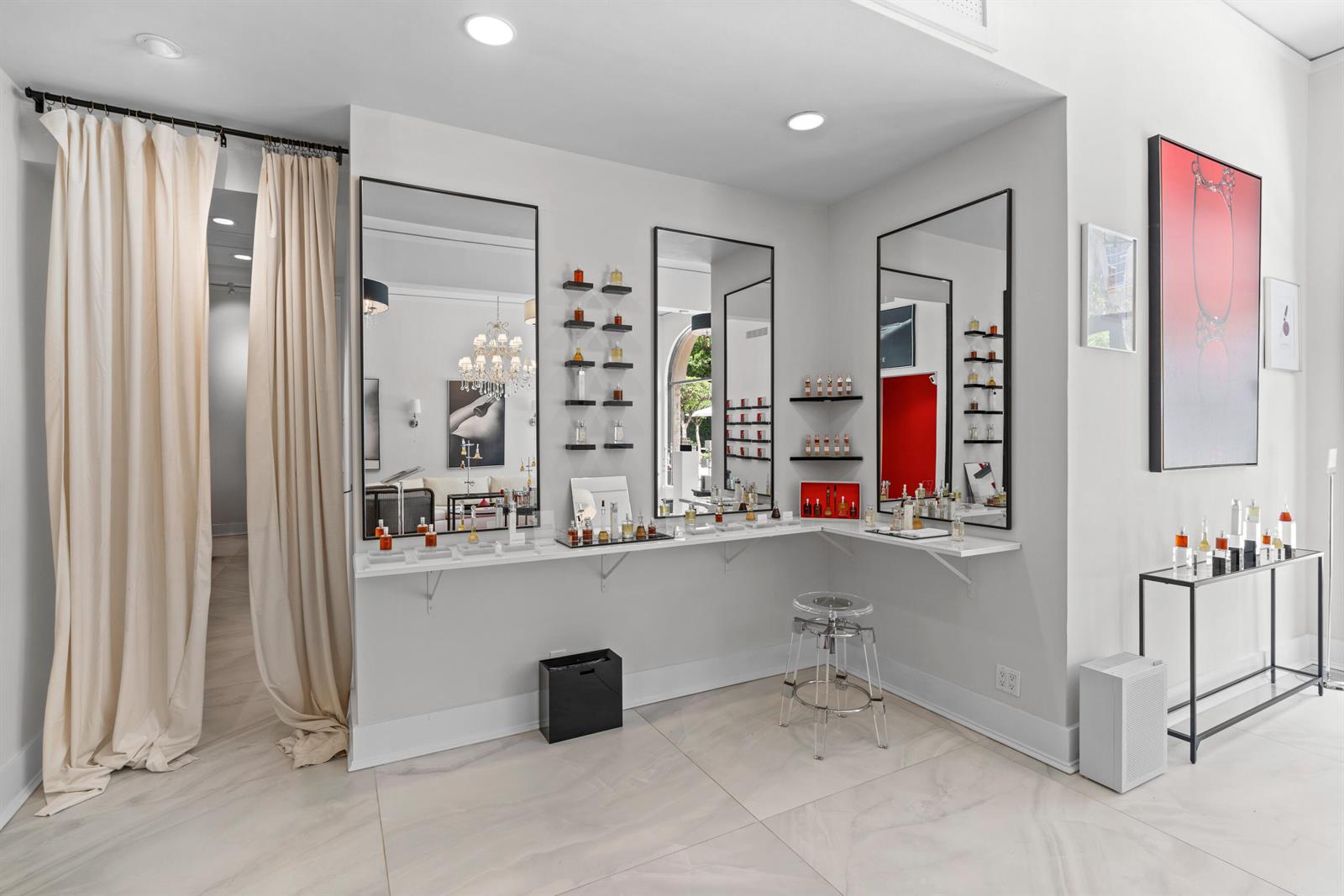 A bright retail space features perfume displays, mirrors, a clear stool, and light-colored flooring — 256 Worth Avenue, Palm Beach FL 33480, PALM BEACH, FL