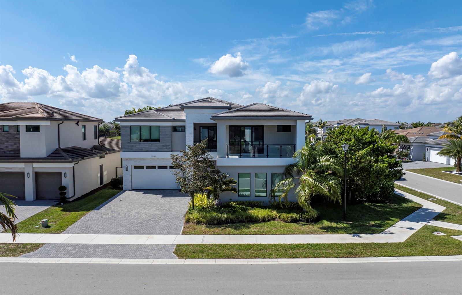 A two-story suburban house with a gray tile roof, white stucco walls, and a paved driveway — 17081 Five Waters Avenue, Boca Raton FL 33496, BOCA RATON, FL