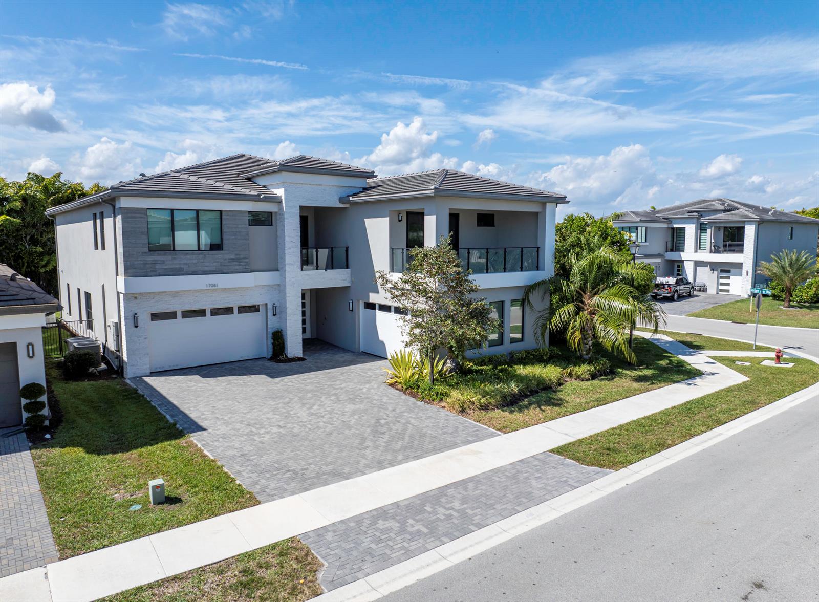 An aerial view of a two-story modern house with a gray tile roof and driveway — 17081 Five Waters Avenue, Boca Raton FL 33496, BOCA RATON, FL