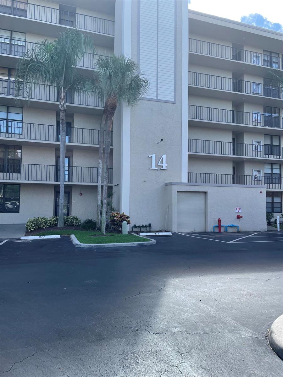 A multi-story apartment building exterior features a large number 14 and a fire department connection — 14 Royal Palm Way # 204, Boca Raton FL 33432, BOCA RATON, FL