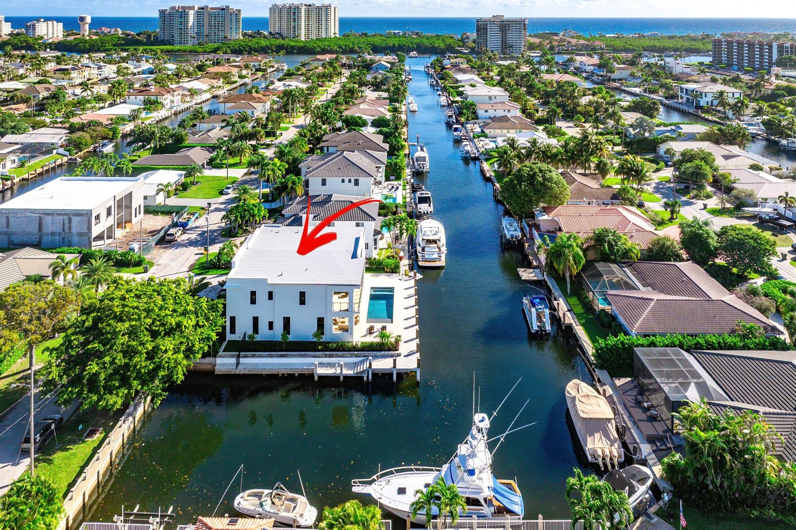 An aerial view of a white waterfront house with a pool along a canal — 728 Enfield Street, Boca Raton FL 33487, BOCA RATON, FL