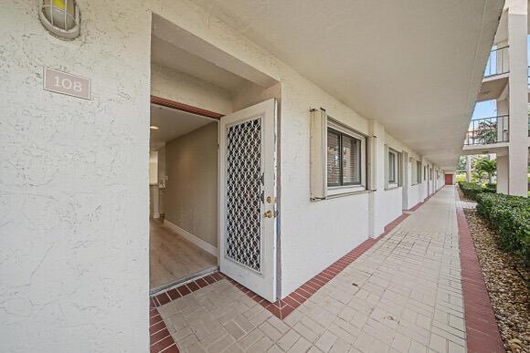 An aerial view shows a multi-story apartment building with a red location pin — 15075 Witney Road # 108, Delray Beach FL 33484, DELRAY BEACH, FL