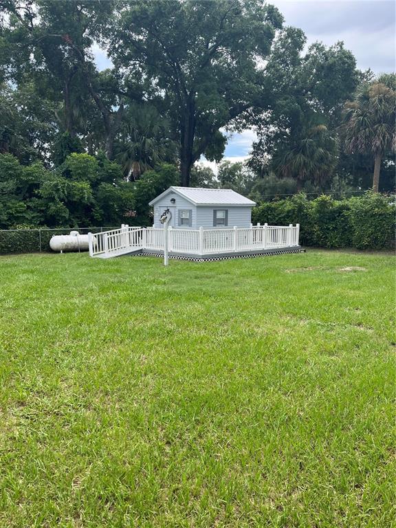 A small light blue shed with a white roof sits on a raised wooden deck — 2392 SE 175TH TERRACE ROAD, SILVER SPRINGS, FL