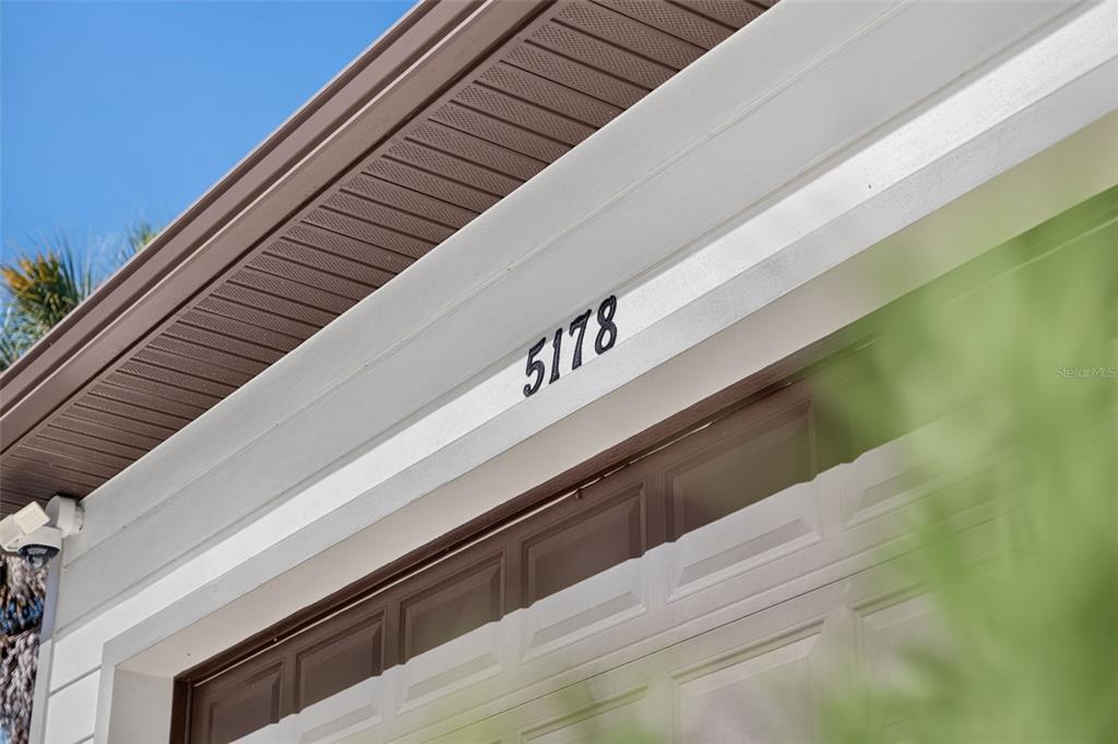 The house number 5178 is mounted on the white trim above a garage door — 5178 FLORIDA ROAD, VENICE, FL