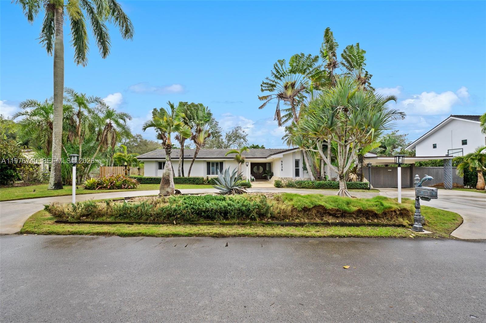 A single-story white house with a circular driveway and lush tropical landscaping — 9838 SW 94th Ter, Miami FL 33176, MIAMI, FL