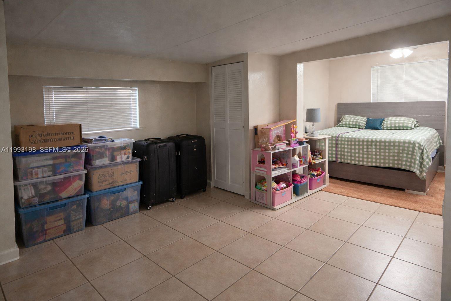 A bedroom with tile flooring, a bed in an alcove, and storage bins — 2353 SW 2nd St, Miami FL 33135, MIAMI, FL