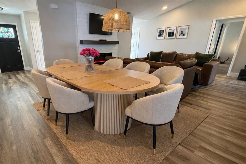 A dining room features an oval wooden table with a fluted base and upholstered chairs — 1413 SANDALWOOD DRIVE, PLANT CITY, FL