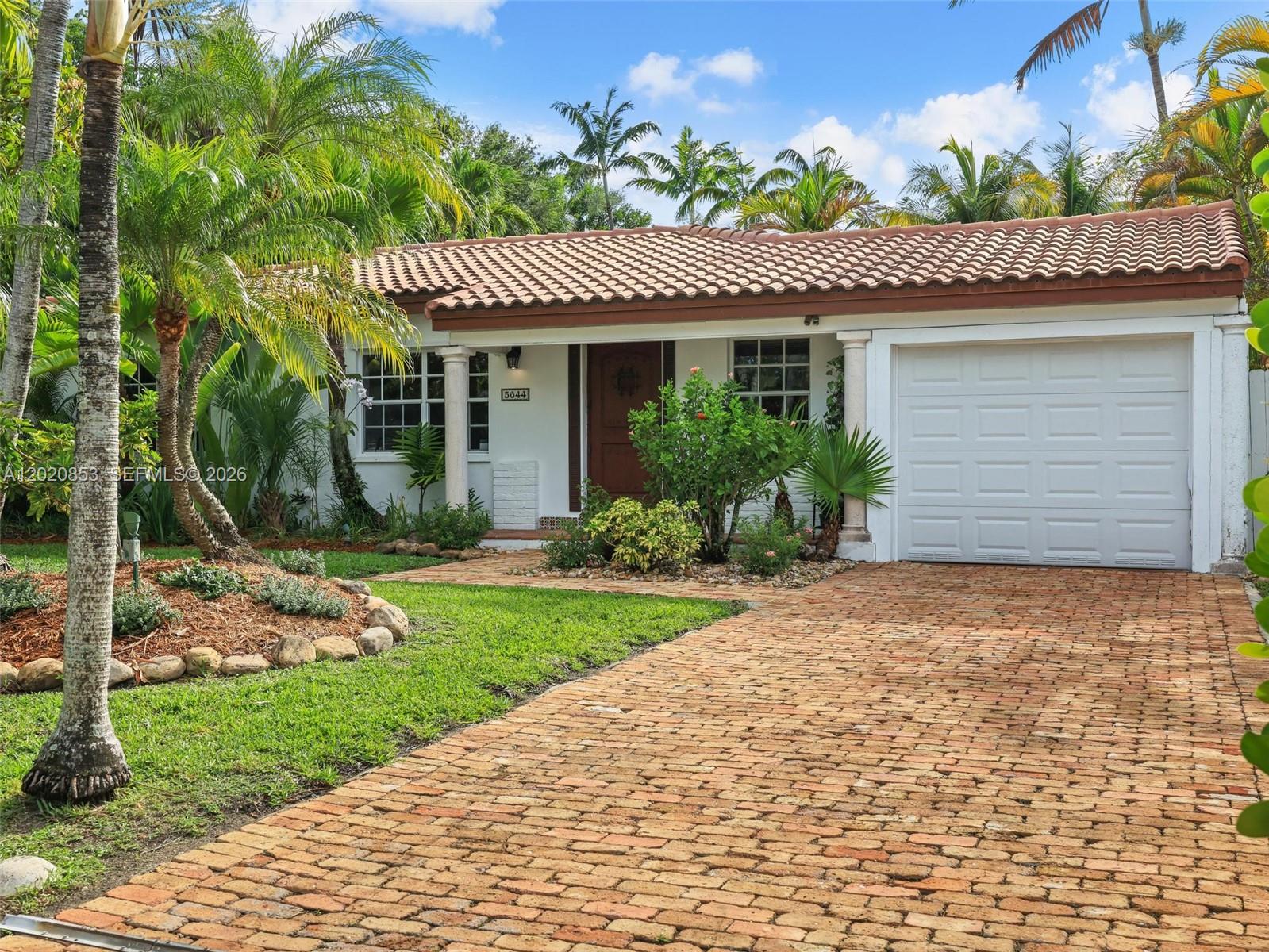 A single-story house with a brick driveway, tile roof, and tropical landscaping — 5644 SW 69th Ave, Miami FL 33143, MIAMI, FL