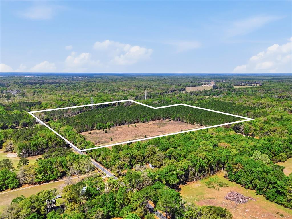 An aerial view shows a large, rectangular plot of land outlined in white — 11791 SW 143RD STREET SW, ARCHER, FL