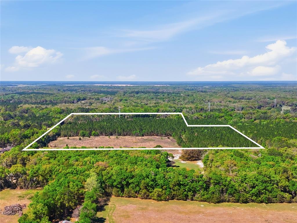 An aerial view shows a large, rectangular plot of land outlined in white — 11791 SW 143RD STREET SW, ARCHER, FL