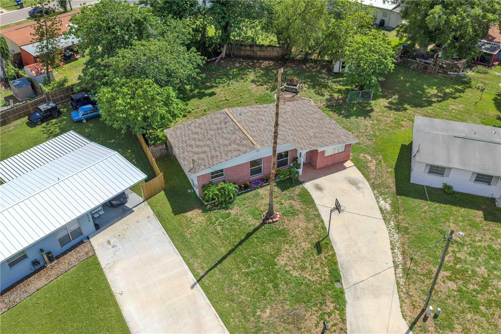 An aerial view shows a single-story brick house with a driveway and a large yard — 508 CLEARFIELD ROAD, BRANDON, FL