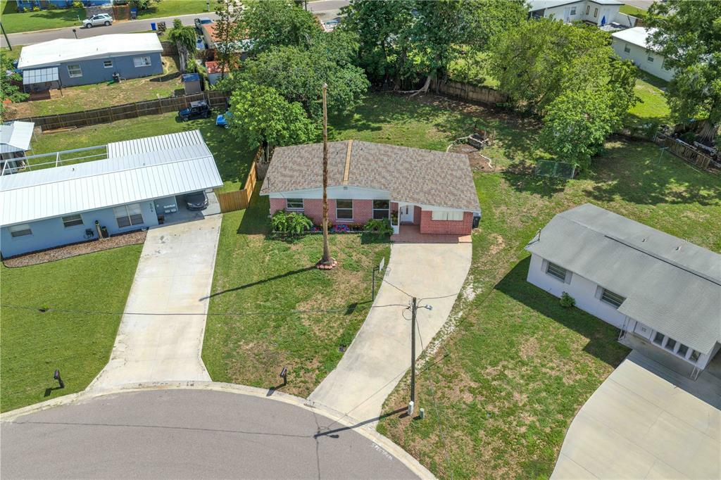 An aerial view shows a single-story brick house with a driveway and a large yard — 508 CLEARFIELD ROAD, BRANDON, FL
