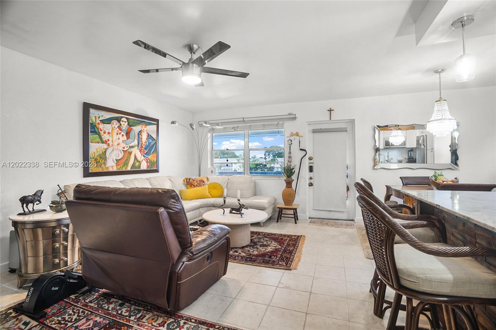 A living room features a white sectional sofa, brown recliner, and an adjacent dining area — 181 Lyndhurst L # 181, Deerfield Beach FL 33442, DEERFIELD BEACH, FL