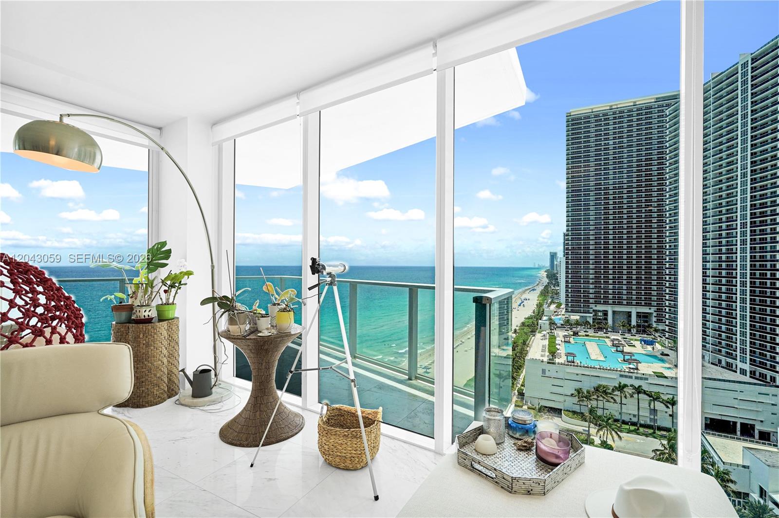 A bright room features floor-to-ceiling windows overlooking the ocean, a balcony, and a telescope — 3951 S Ocean Dr # 1901, Hollywood FL 33019, HOLLYWOOD, FL