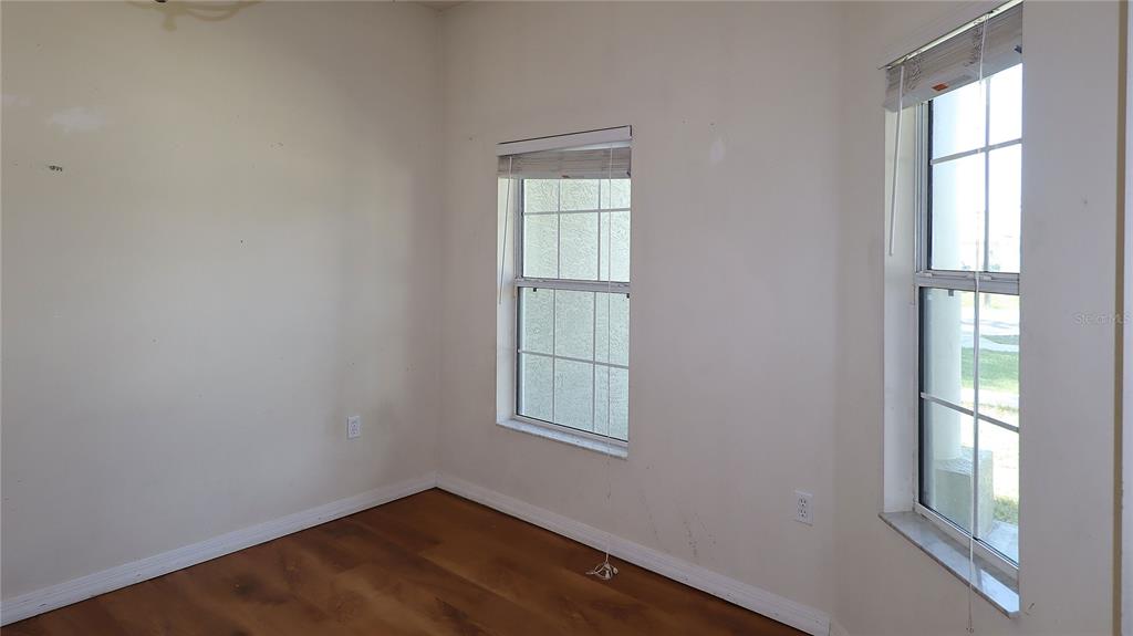 A kitchen features dark wood cabinets, granite countertops, and white appliances — 3114 NE 24TH PLACE, OCALA, FL