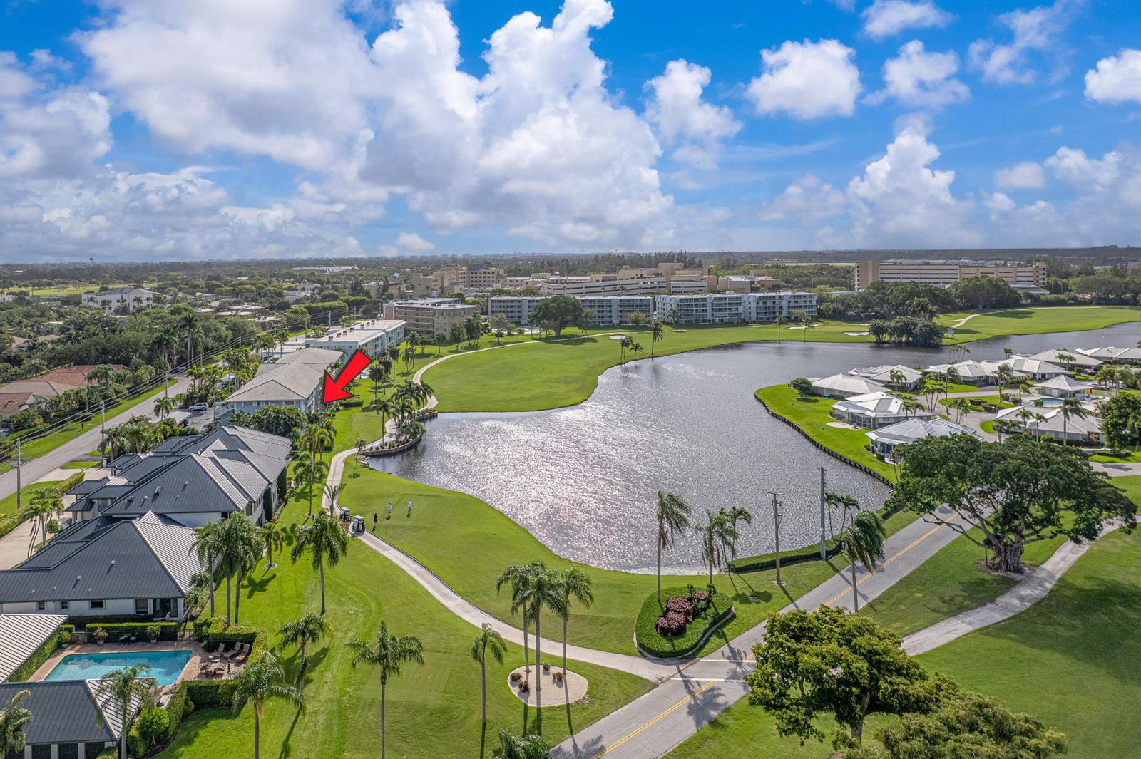 A gray exterior walkway features white railings, a brick wall section, and two screened doors — 169 Atlantis Boulevard # 205, Atlantis FL 33462, ATLANTIS, FL