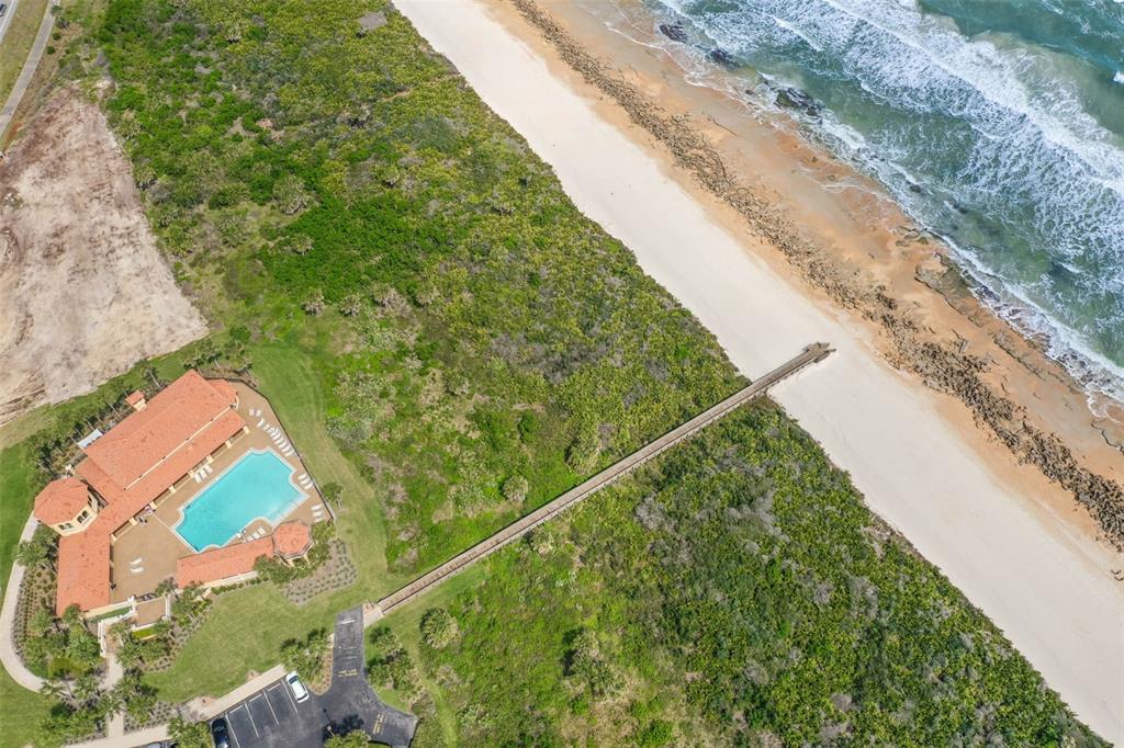 An aerial view shows a house with a pool, a wooden walkway, and a beach — 104 SURFVIEW DRIVE UNIT 1608, PALM COAST, FL