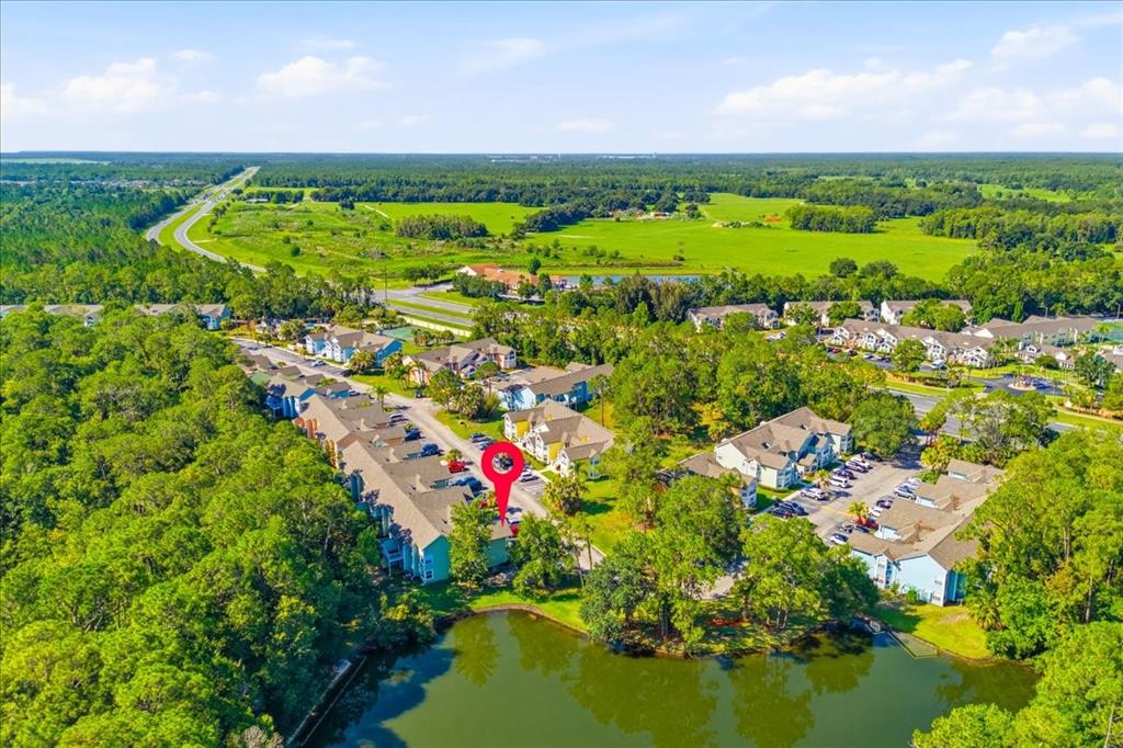 A two-story apartment building with light green siding and a parking lot in front — 2041 ROYAL BAY BOULEVARD UNIT 33, KISSIMMEE, FL