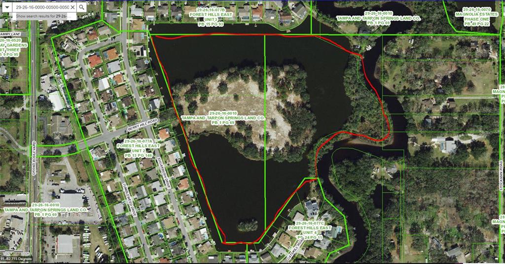 This is a satellite map showing a land parcel outlined in red surrounded by water — 0 BERRY HILL ROAD, HOLIDAY, FL