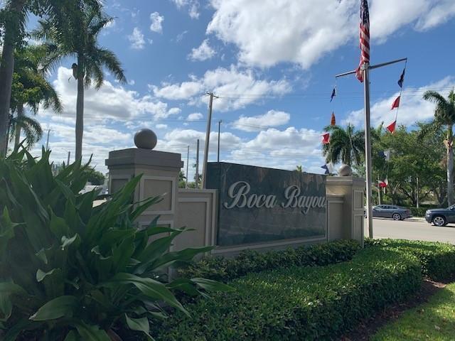A stone monument sign for Boca Bayou stands near palm trees and a flagpole — 26 Royal Palm Way # 302, Boca Raton FL 33432, BOCA RATON, FL