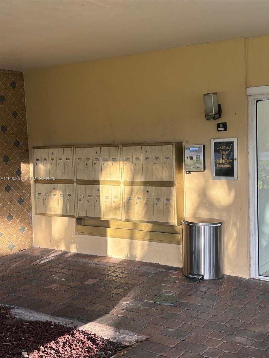 A set of metal mailboxes is mounted on a beige wall near a building entrance — 555 Crandon Blvd # 43, Key Biscayne FL 33149, KEY BISCAYNE, FL