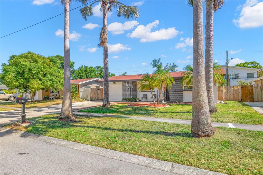 A single-story house with a brick facade and palm trees in the front yard — 2536 KEENE PARK DRIVE, LARGO, FL