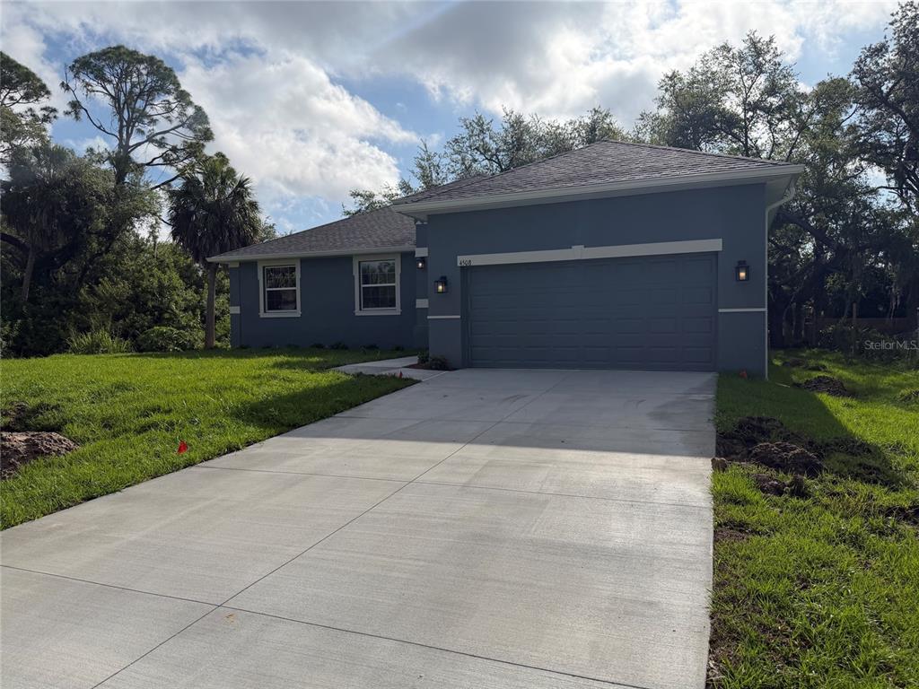A gray single-story house with a two-car garage and a concrete driveway — 4508 BRINTNALL STREET, PORT CHARLOTTE, FL