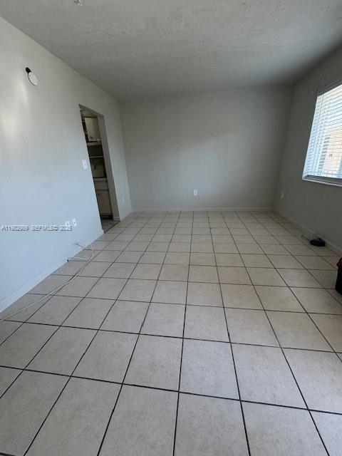An empty room features light-colored tile flooring, plain walls, and a window with blinds — 8601 SW 68th Ct # 23, Pinecrest FL 33156, PINECREST, FL