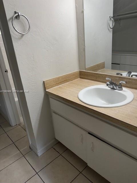 A bathroom vanity features a light wood-look countertop, a white sink, and white cabinets — 8601 SW 68th Ct # 23, Pinecrest FL 33156, PINECREST, FL