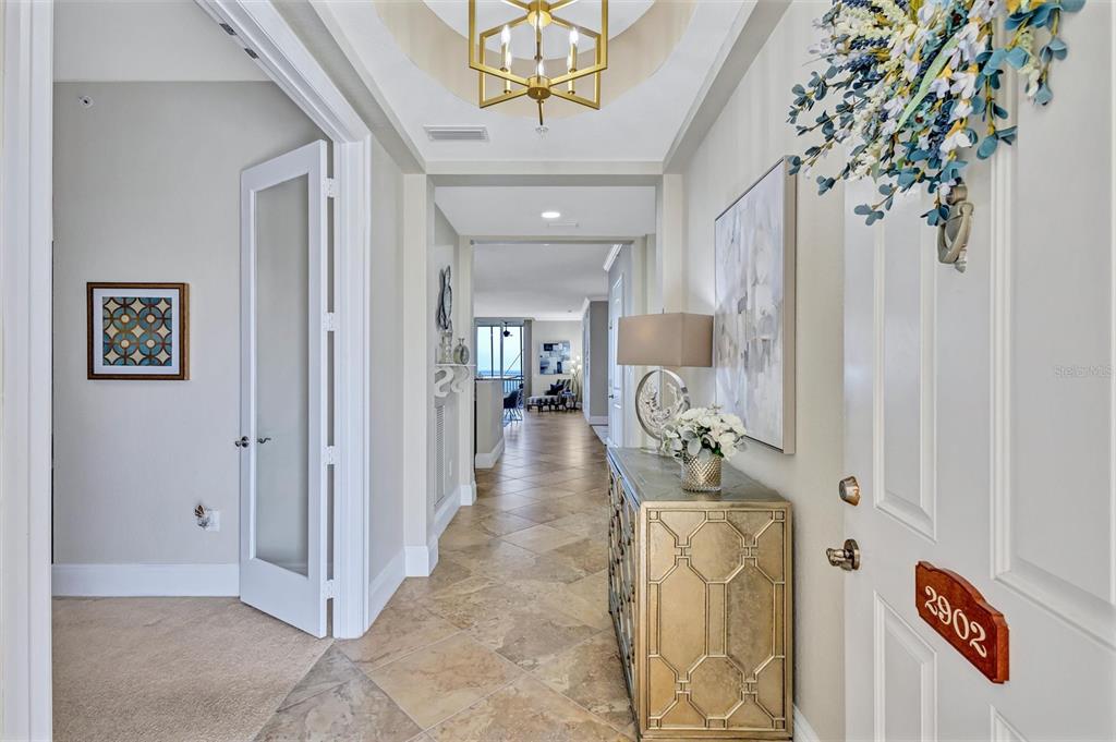 An entryway with tile flooring, a gold console table, and a view into the home — 2925 TERRA CEIA BAY BOULEVARD UNIT 2902, PALMETTO, FL
