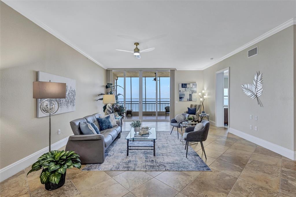 A living room features a gray sofa, glass coffee table, and sliding doors to a balcony — 2925 TERRA CEIA BAY BOULEVARD UNIT 2902, PALMETTO, FL