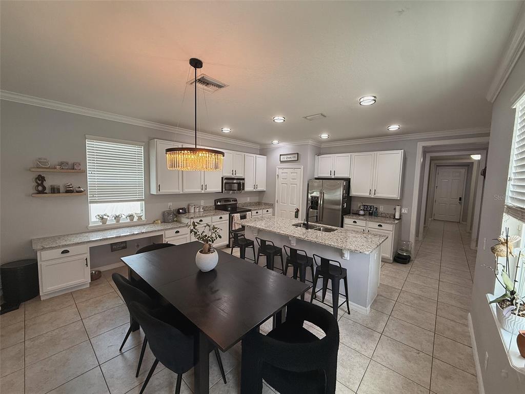 An aerial view shows a community swimming pool, hot tub, playground, and clubhouse — 5253 SUNCATCHER DRIVE, WESLEY CHAPEL, FL