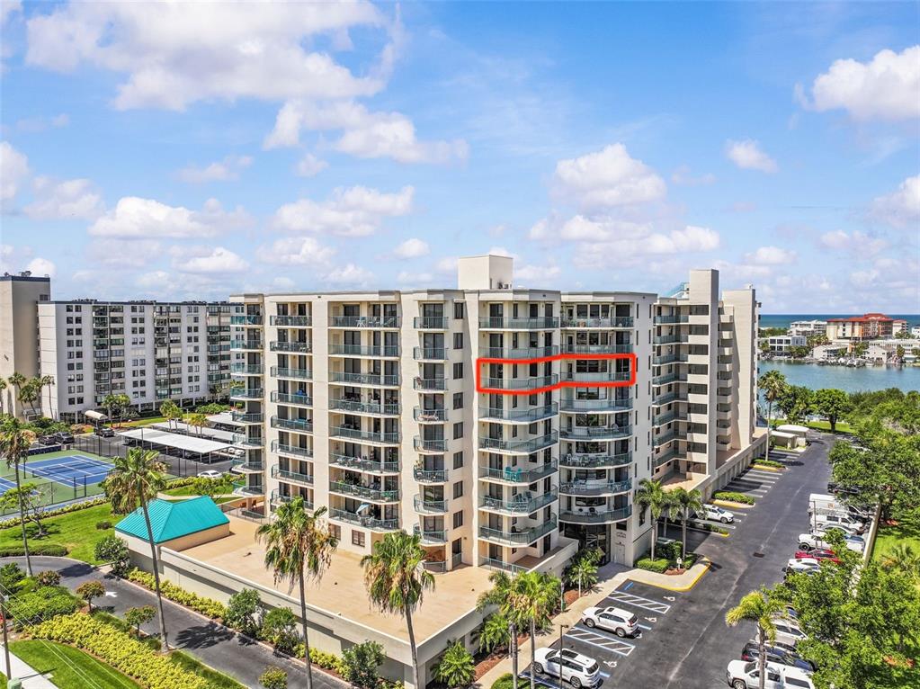 An exterior view of a multi-story apartment building with a red box highlighting a balcony — 670 ISLAND WAY UNIT 800, CLEARWATER BEACH, FL