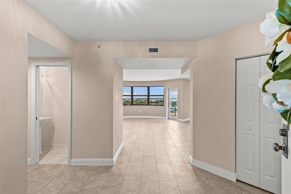 A tiled entryway leads to a living area with large windows overlooking the water — 670 ISLAND WAY UNIT 800, CLEARWATER BEACH, FL