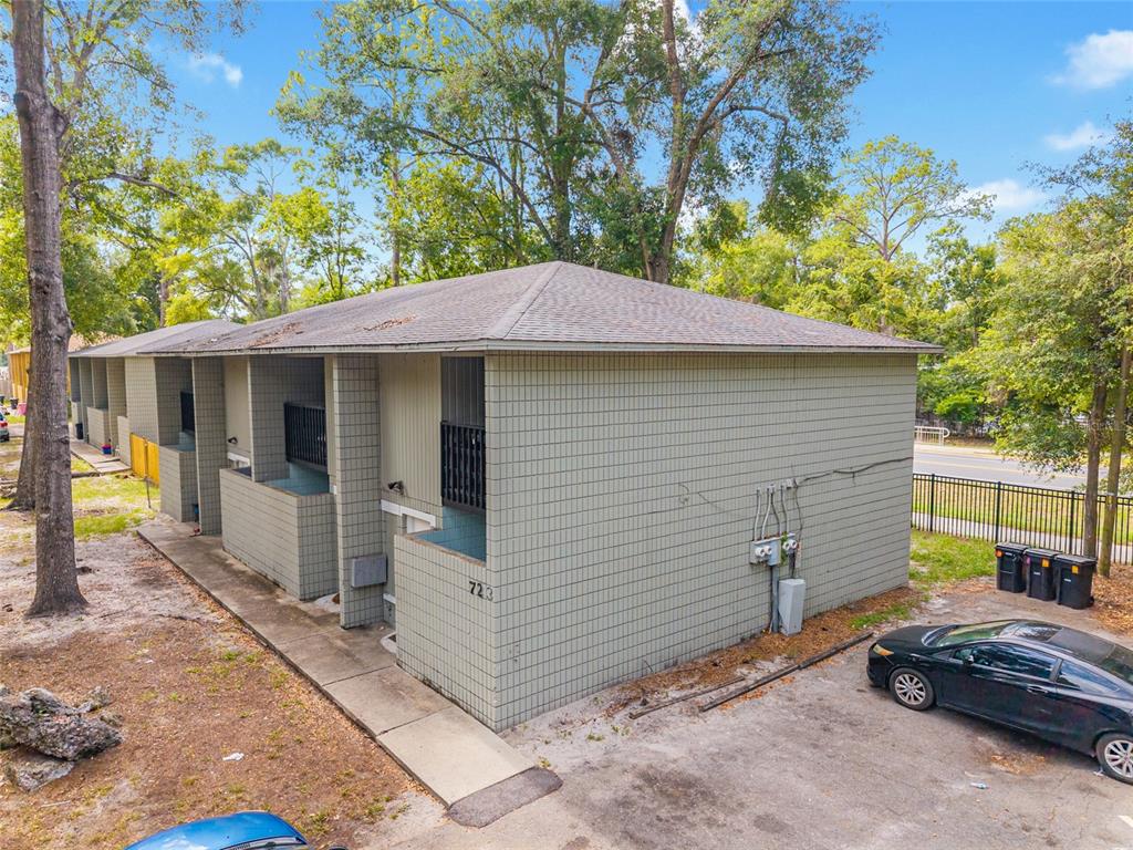 An exterior view of a two-story apartment building with light green tiled walls — 723 SW 69TH STREET, GAINESVILLE, FL