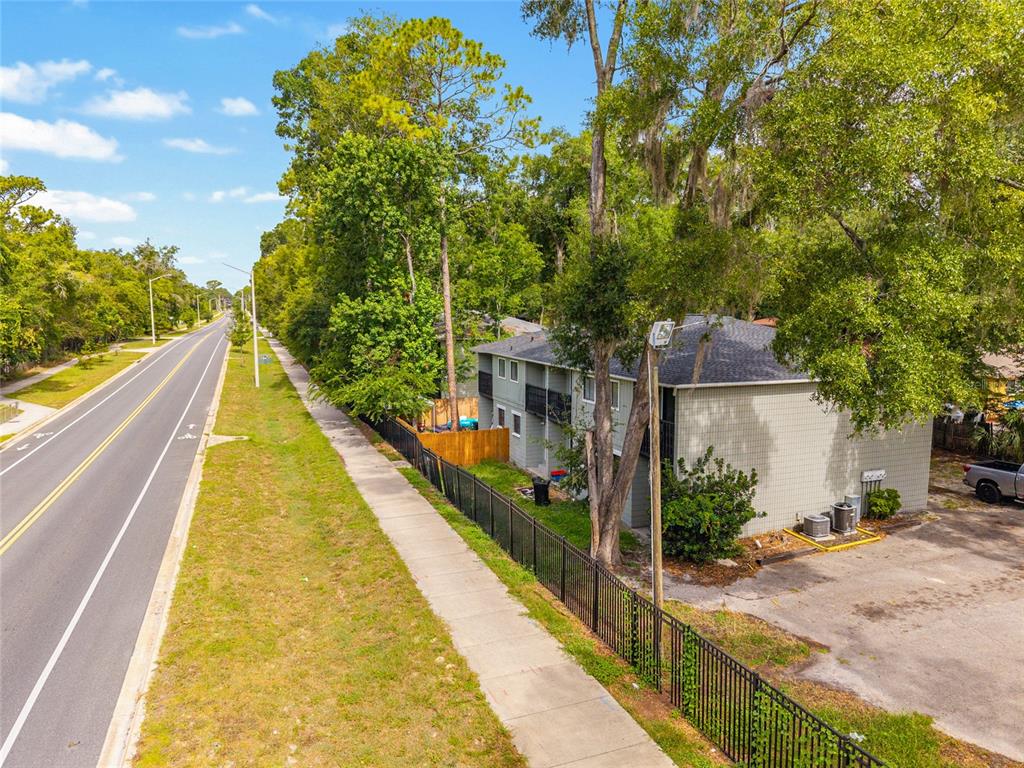 An aerial view shows a two-story apartment building next to a road and sidewalk — 723 SW 69TH STREET, GAINESVILLE, FL