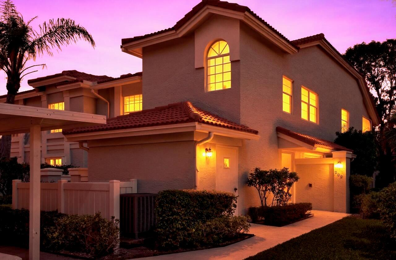 A two-story stucco townhouse with a red tile roof and a white front door — 7669 Springwater Place # 202, Boynton Beach FL 33437, BOYNTON BEACH, FL