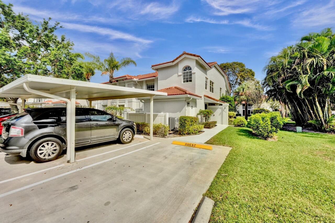 A two-story stucco townhouse with a red tile roof and a small front walkway — 7669 Springwater Place # 202, Boynton Beach FL 33437, BOYNTON BEACH, FL
