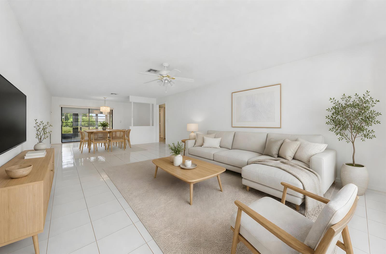 A bright living and dining room with white tile floors, a sectional sofa, and furniture — 9795 Tabebuia Tree Drive # B, Boynton Beach FL 33436, BOYNTON BEACH, FL