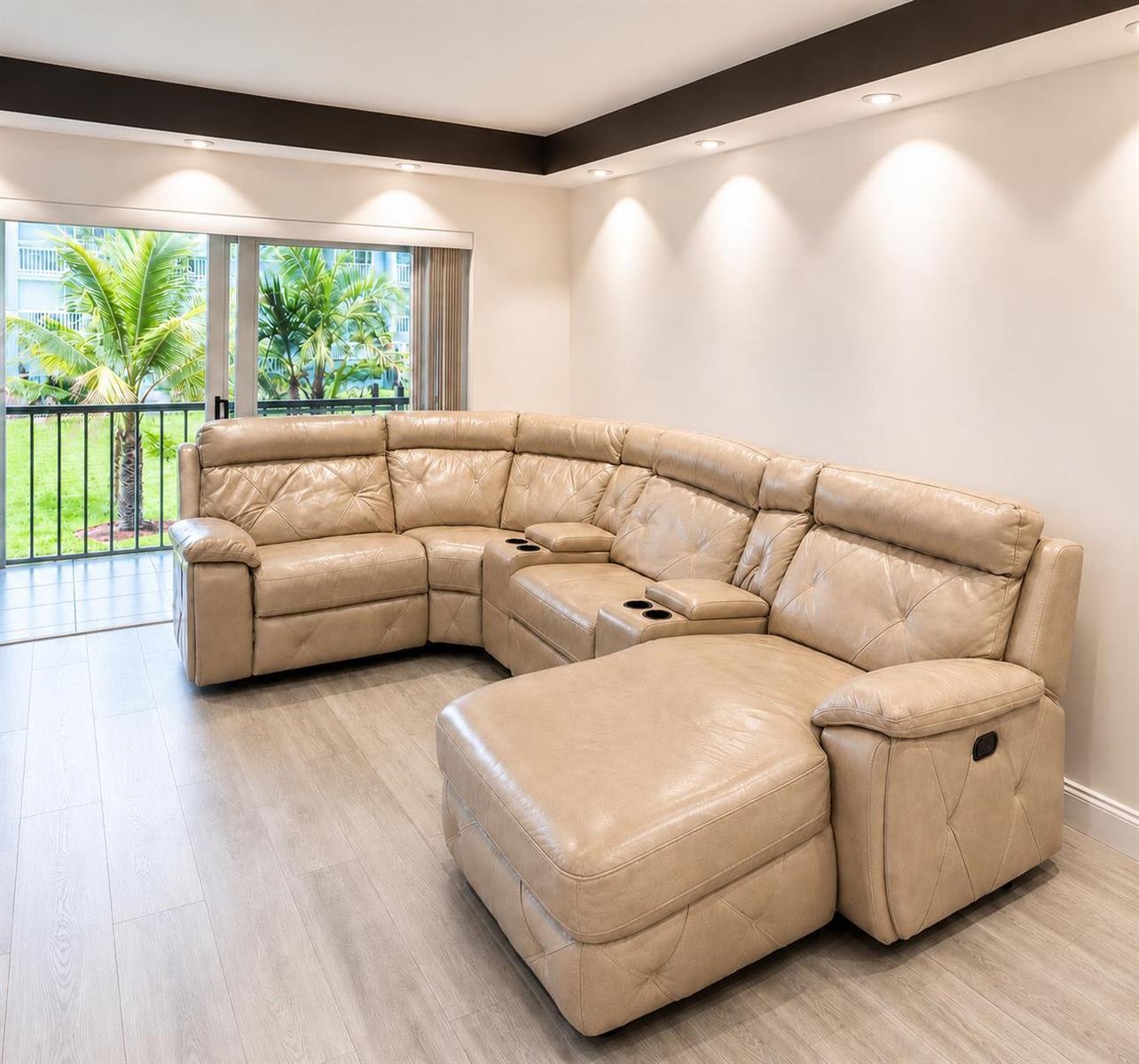 A beige leather sectional sofa sits on light wood flooring in a room with recessed lighting — 9880 Marina Boulevard # 1520, Boca Raton FL 33428, BOCA RATON, FL