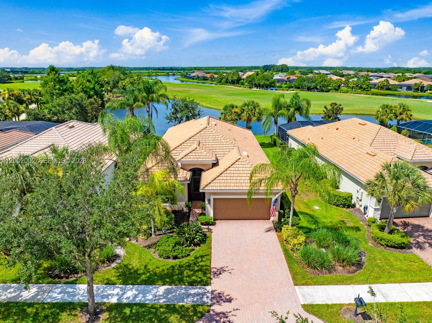 An aerial view of a single-story house with a tile roof and a brick driveway — 6392 Liberty St, Ave Maria FL 34142, AVE MARIA, FL