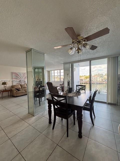 A dining area with a wooden table and chairs sits before a balcony overlooking water — 1400 S Ocean Dr # 304, Hollywood FL 33019, HOLLYWOOD, FL