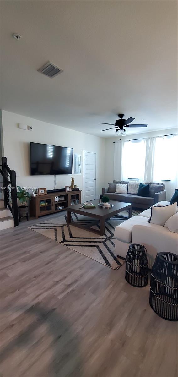 A living room features a large television, a wooden media console, and a sectional sofa — 10473 NW 82nd St # 11, Doral FL 33178, DORAL, FL
